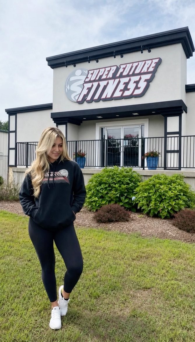 Member standing in front of the Super Future Fitness building